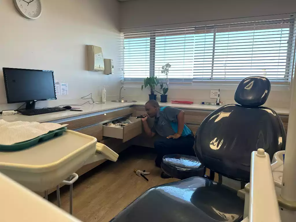 Mikil pest control technician inspecting a commercial healthcare treatment room